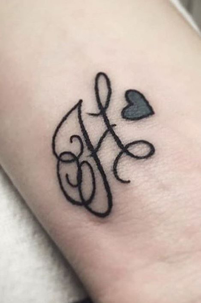 H raidės tatuiruotė su širdimi