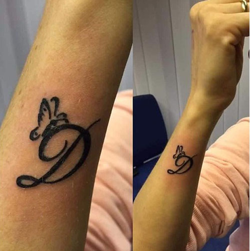 D raidės tatuiruotės dizainas riešo pusėje