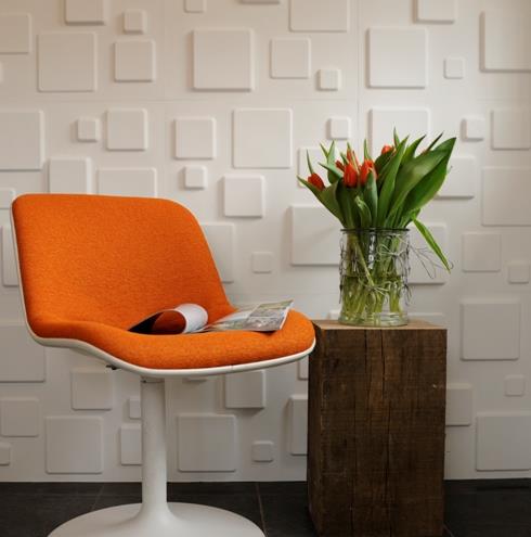 Τρισδιάστατος τοίχος που καλύπτει λευκά τετράγωνα πορτοκαλί άνετη καρέκλα καθιστικό