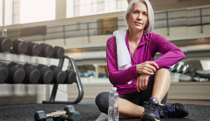 Χάνοντας βάρος ηλικιωμένη γυναίκα κατά τη διάρκεια προπόνησης με βάρη στο γυμναστήριο Ασκήσεις με βάρη μόνο για καλά εκπαιδευμένους ηλικιωμένους