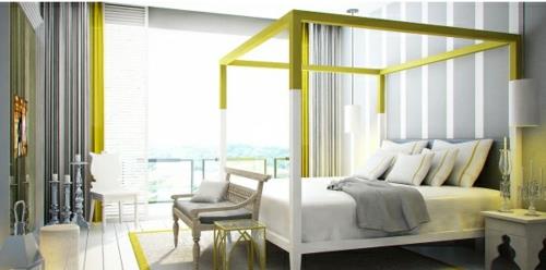 Τέσσερα κρεβάτια με αφίσες στο κίτρινο πλαίσιο του υπνοδωματίου