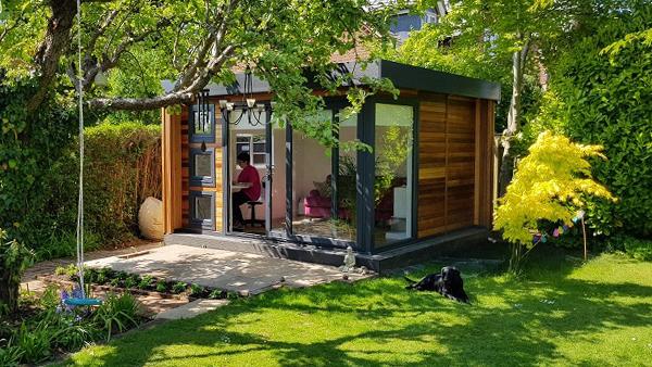 Γραφείο στο σπίτι στον κήπο ενσωματωμένο σε πράσινη, ευχάριστη ατμόσφαιρα