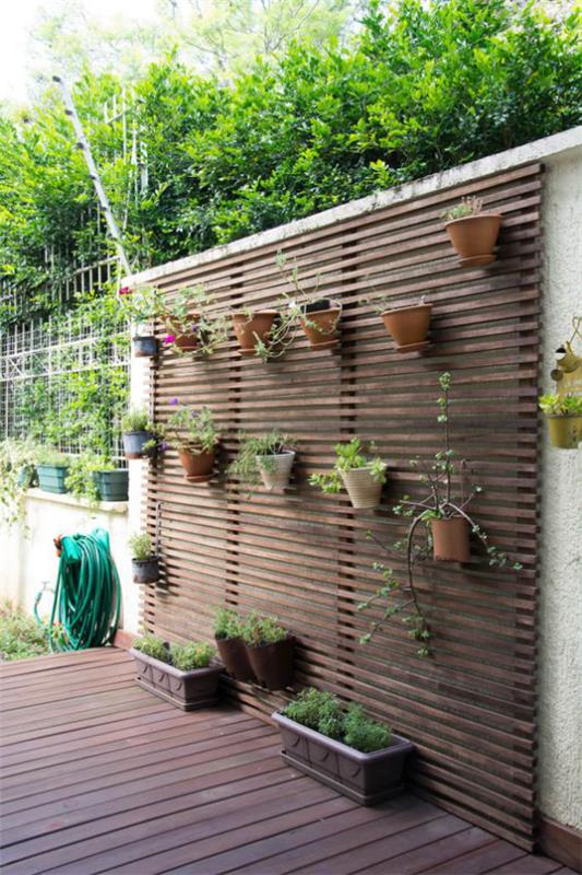 Υπαίθρια - Τάσεις 2020 Πράσινος τοίχος έξω από γλάστρες στα ξύλινα κουτιά τοίχου με πράσινα φυτά