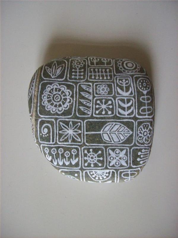 Πέτρες που ζωγραφίζουν αφηρημένα μοτίβα λευκή χειροτεχνία με πέτρες