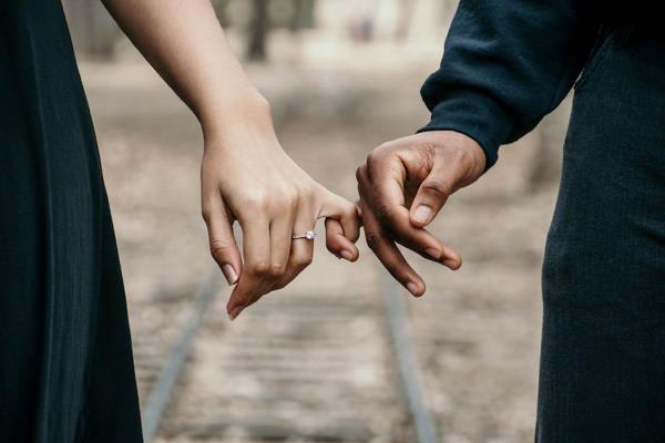 τρία ζωδιακά ζευγάρια που κρατούν τα χέρια νεαρή γυναίκα που φορά δαχτυλίδι αρραβώνων