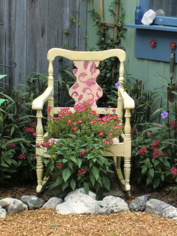 κήπος διακοσμούν ξύλινες παλιές καρέκλες λουλούδια πέτρες