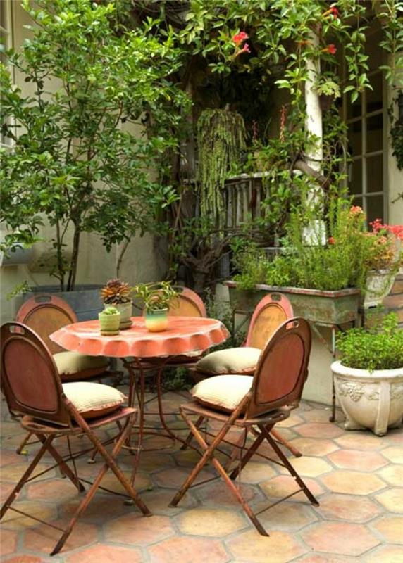 ιδέες σχεδιασμός κήπου στρογγυλό μεταλλικό τραπέζι ρουστίκ τραπέζι κήπου