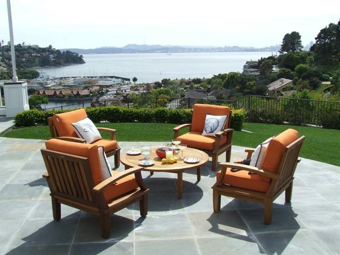 πολυθρόνα κήπου πορτοκαλί μαξιλάρι καθίσματος στρογγυλό τραπέζι κήπου