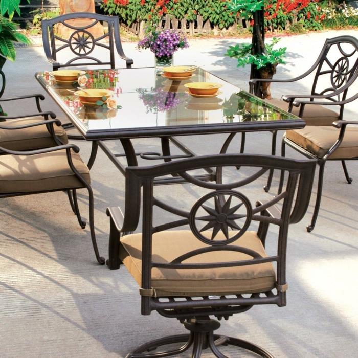 τραπέζι κήπου γυάλινο τραπέζι κομψές καρέκλες κήπου μαξιλάρια καθισμάτων