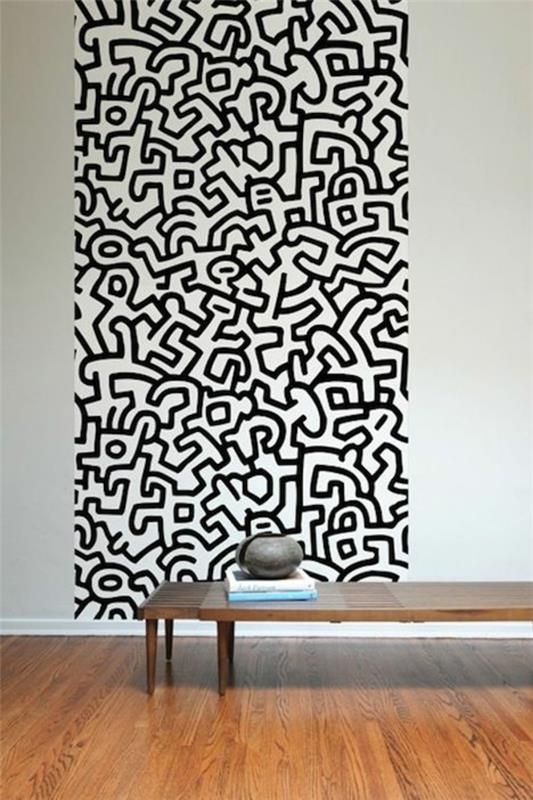 ιδέες σχεδιασμός τοίχου σαλονιού μαύρος τοίχος μοτίβο ταπετσαρίας Keith haring
