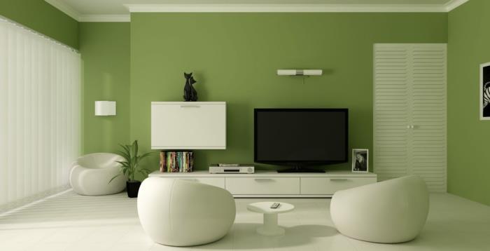 Μικρό σαλόνι με χρώμα τοίχου πράσινο λευκό στρογγυλό πολυθρόνες ράφια τοίχου