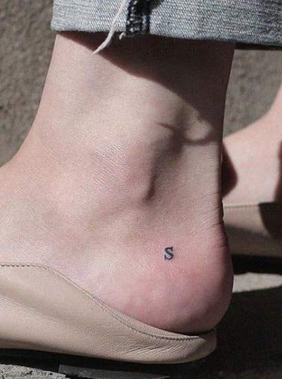 „Capital S“ tatuiruotė ant kulno