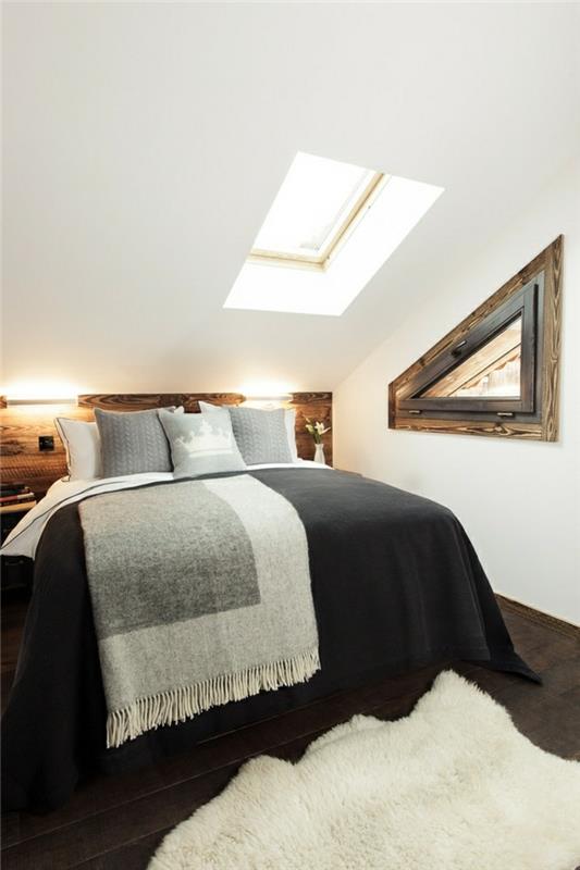 υπνοδωμάτιο με κεκλιμένη οροφή μαύρο κρεβάτι και λευκό χαλί γούνας