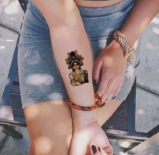 Moteris su maža actekų tatuiruote