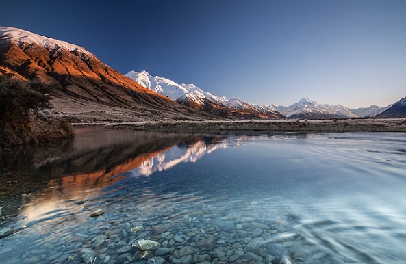 Žiemos saulėtekis, žiūrintis per Tasmano upę link Aoraki / Mt Cook kalno, apsnigto, Mackenzie Country, Kenterberis, Naujoji Zelandija